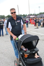 Fred Nason, who owns Nason's Landscaping which is a longtime sponsor of racing in and around northern Illinois, pushes his grandson through the infield. This was the first Five Flags Speedway visit for Fred and his son Austin Nason, who competed in his first Derby. (Jim Carson photo)