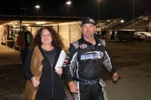 Former Late Model driver and current modified racer Ricky Moxley finishes an order from Brooke Jones, the wife of longtime track photographer and Speedweeks fixture Jim Jones.