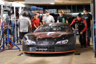 Jeremy Miller pushes his car through part of the tech line. Miller won two Pro Late Model races but had one taken away because of a body panel measurement violation. (Kim Kemperman photo)