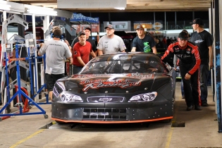 Jeremy Miller pushes his car through part of the tech line. Miller won two Pro Late Model races but had one taken away because of a body panel measurement violation. (Kim Kemperman photo)