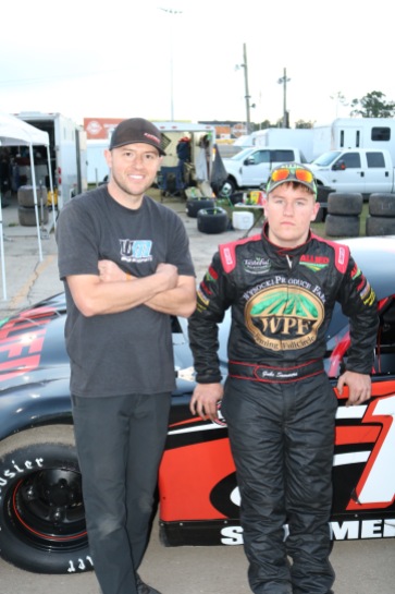 Wisconsin teenager Gabe Sommers (right), the Super Late Model points runner-up, debriefs after qualifying with his adviser for the week, Travis Sauter.