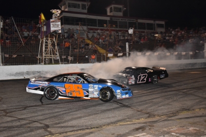 Page 6 (track report; Sherri Stearns Photography & Graphic Design) last lap of the June 29 LMSC nightcap at Hickory Motor Speedway; Kevin Leicht (25) and Austin McDaniel (12)