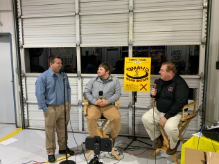 Host Charles Head (right) and his first producer Dave Sherman (left) chat with dirt Late Model driver Kenny Collins. "Super Dave" competed in sportsman races at Lanier for several years. (The yellow sign is backwards here so it could show up on Facebook Live.
